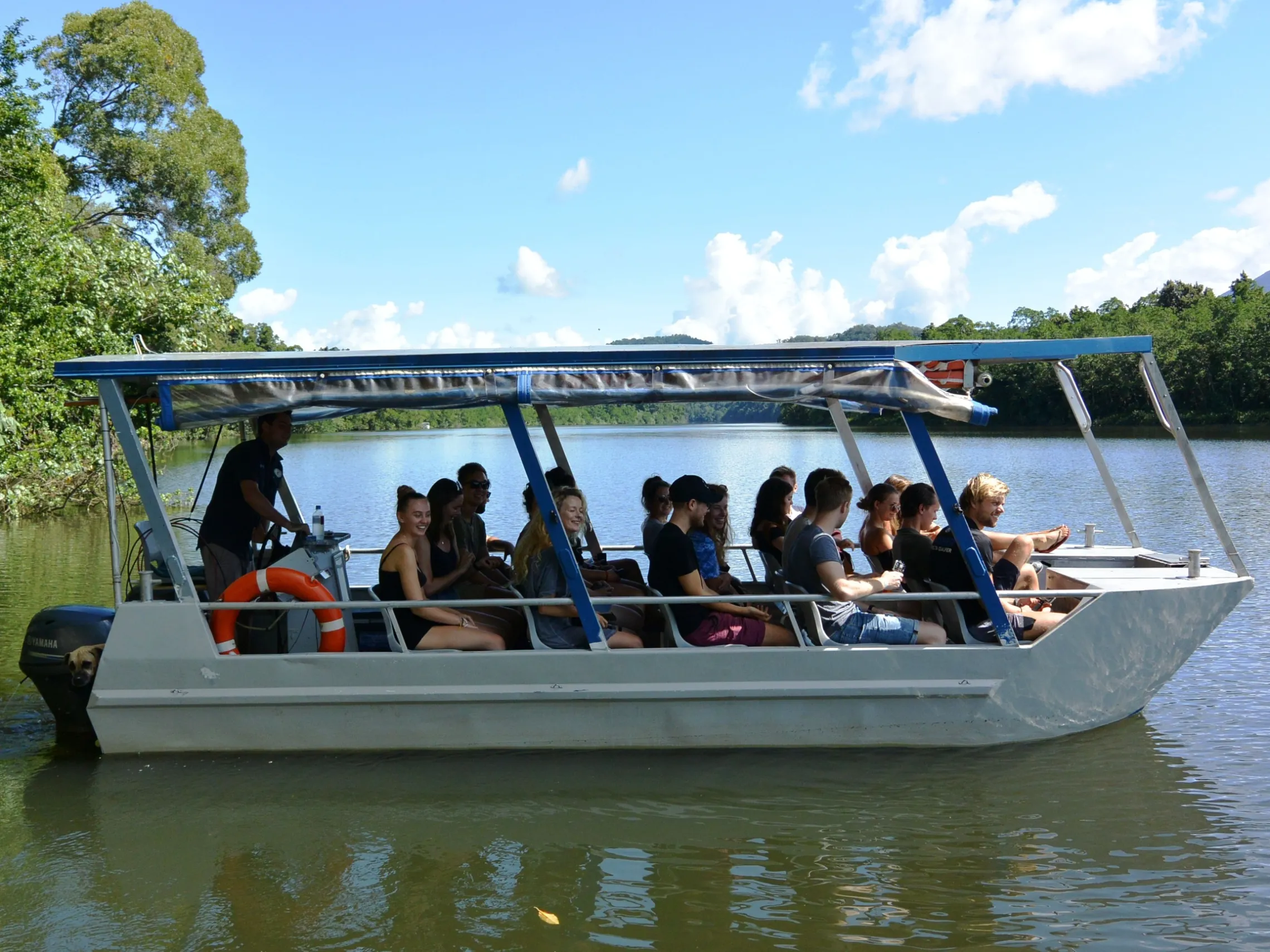 a group of people in a small boat in a body of water