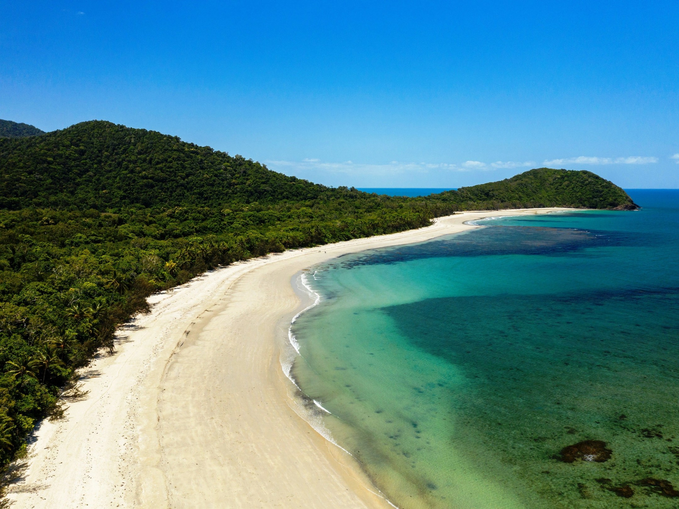 a body of water with a mountain in the background