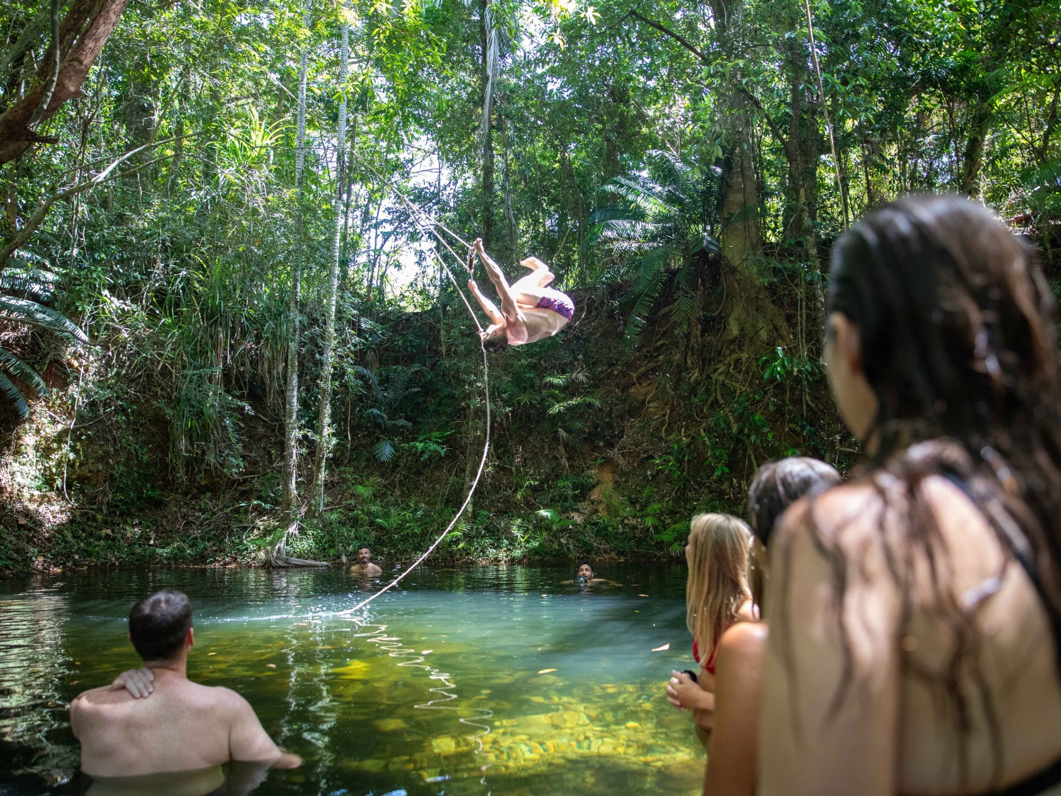 a group of people standing in a river