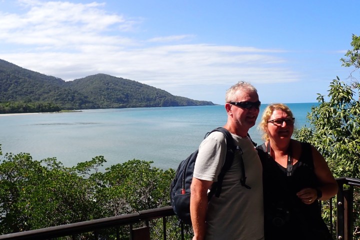 a man standing in front of a lake