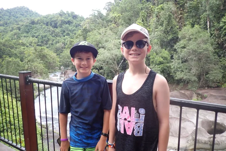 a person standing next to a fence