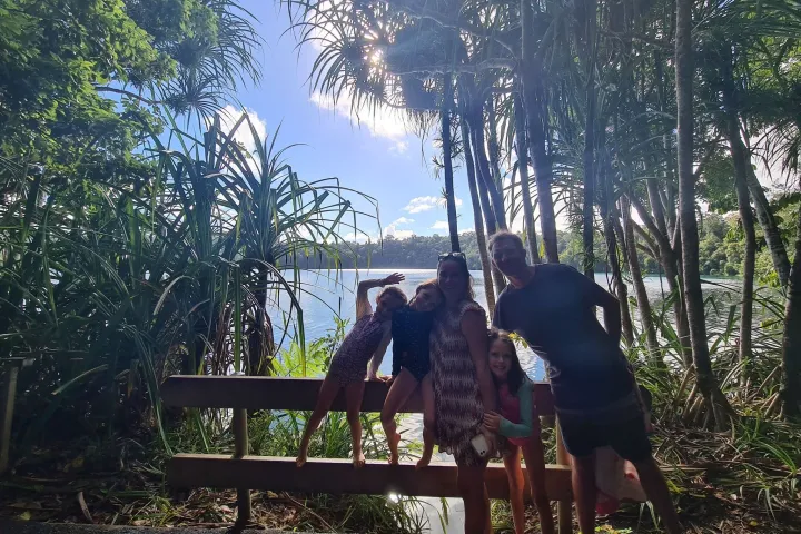 a person sitting on a bench in front of a tree