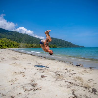 a man standing on top of a sandy beach