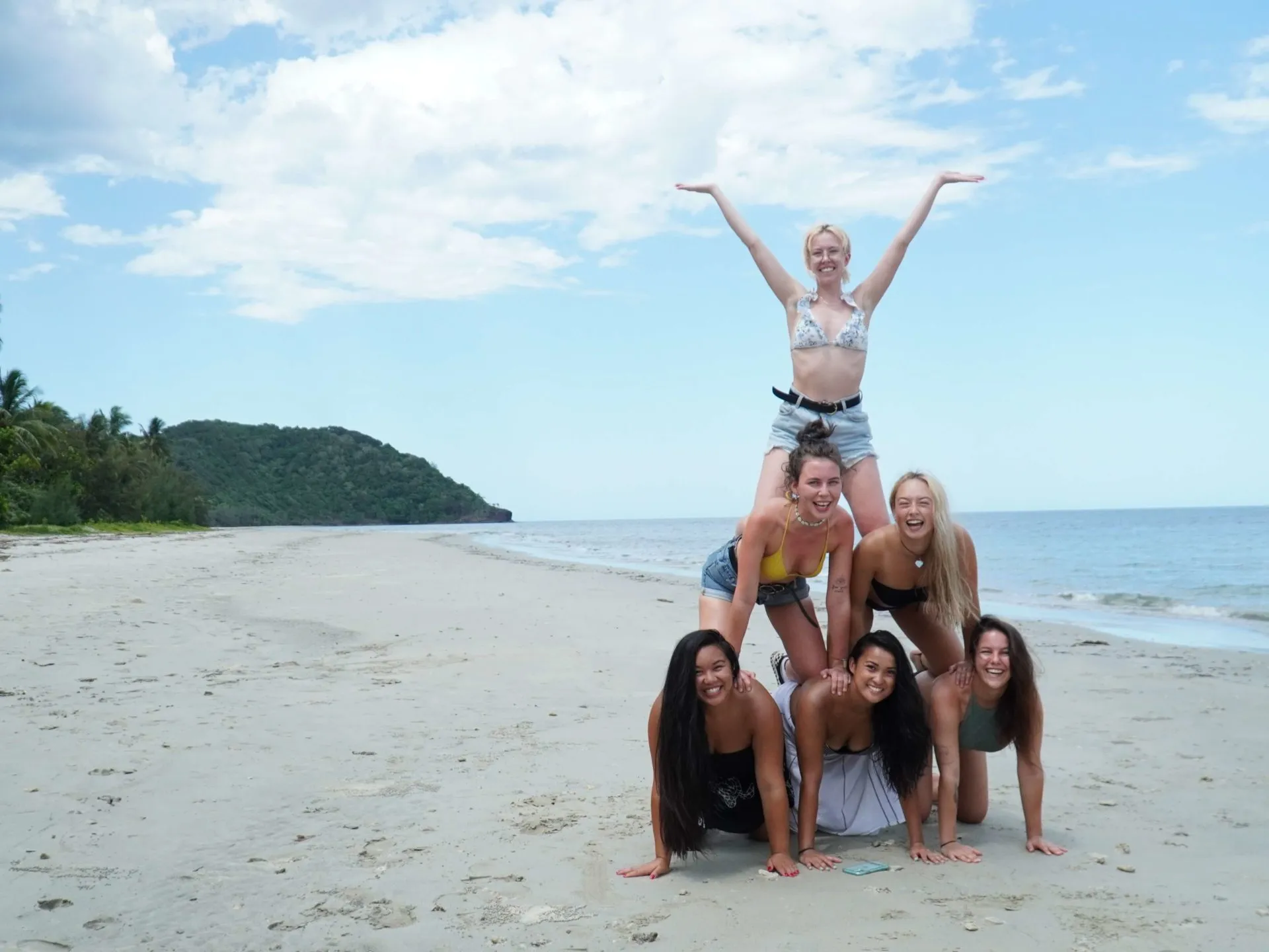 a pyramid of people on a beach