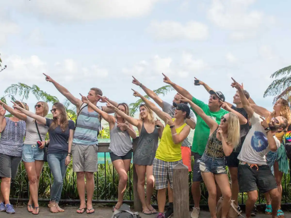 a group of people standing in front of a crowd posing for the camera