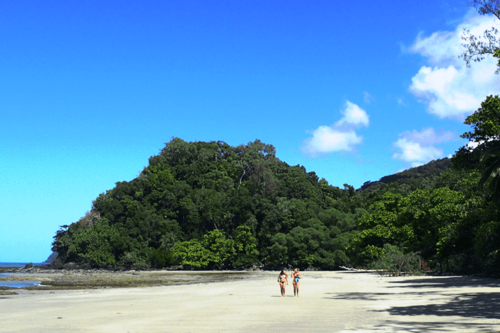 a person standing next to a lake